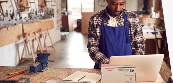 Small business owner preparing to ship Priority Mail packages.